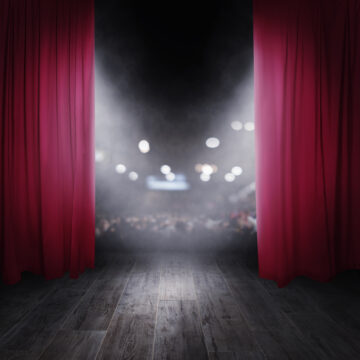 The red curtains are opening for the theater show